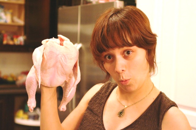 A woman with raw chicken Photo: Luz, Flickr