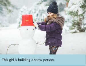 This girl is building a snow person.